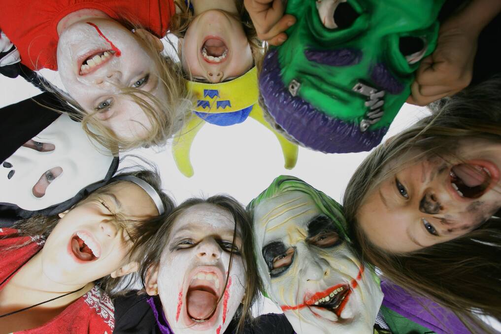 A group of children pose in costume before trick or treating home on Halloween in Sydney. Photo by Sergio Dionisio/Getty Images
