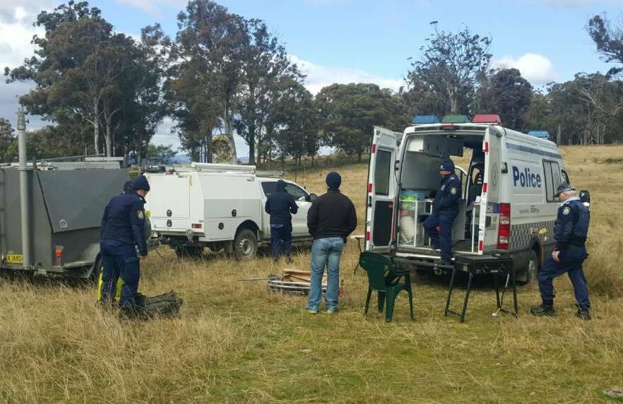 Difficult terrain: Local police as well as forensic officers at the staging area for the operation in the Wild Rivers National Park near Armidale.
