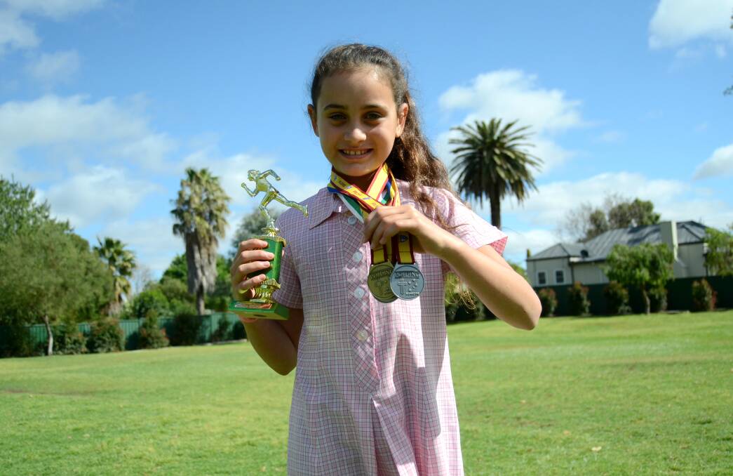 ATHLETE: St Mary's Catholic School student, Natayah Misiepo-Kelly, with a collection of her winnings. Photo: ELOUISE HAWKEY