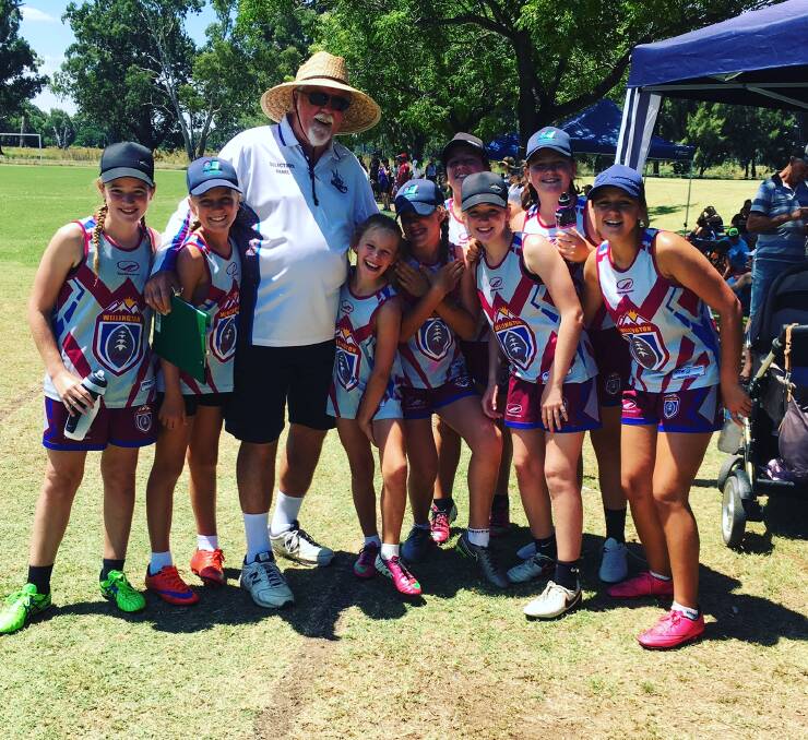MILESTONE YEAR: Don Green with junior players from the Wellington Touch Football Club. Photo: CONTRIBUTED 