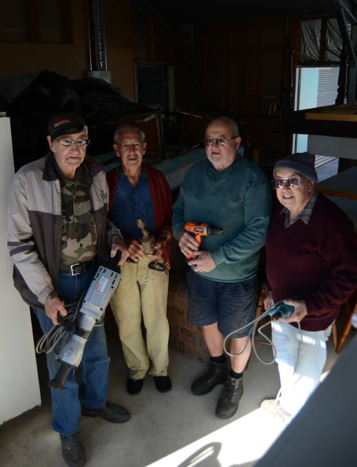 MONSTER SALE: Men's Shed members Ken Pocknoll, Harold Pope, Bill Redern and Neil Blake will spend the week preparing for Saturday's sale. They are pictured with some of the sale items. Photo: ELOUISE HAWKEY