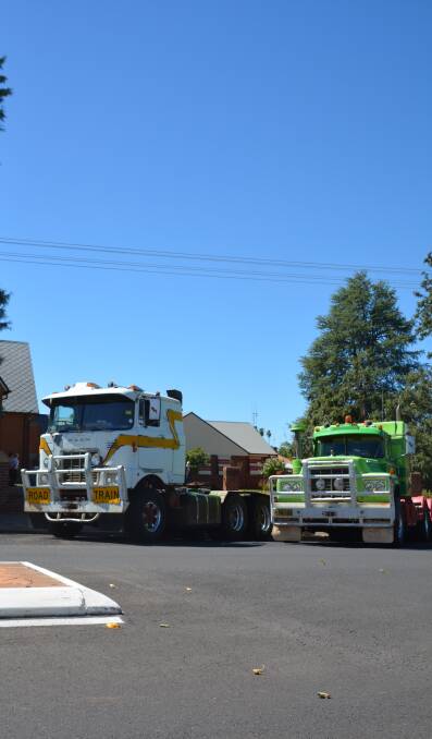 Two of the trucks in the procession outside of St John the Baptist Church. Photo: NICK GRIMM