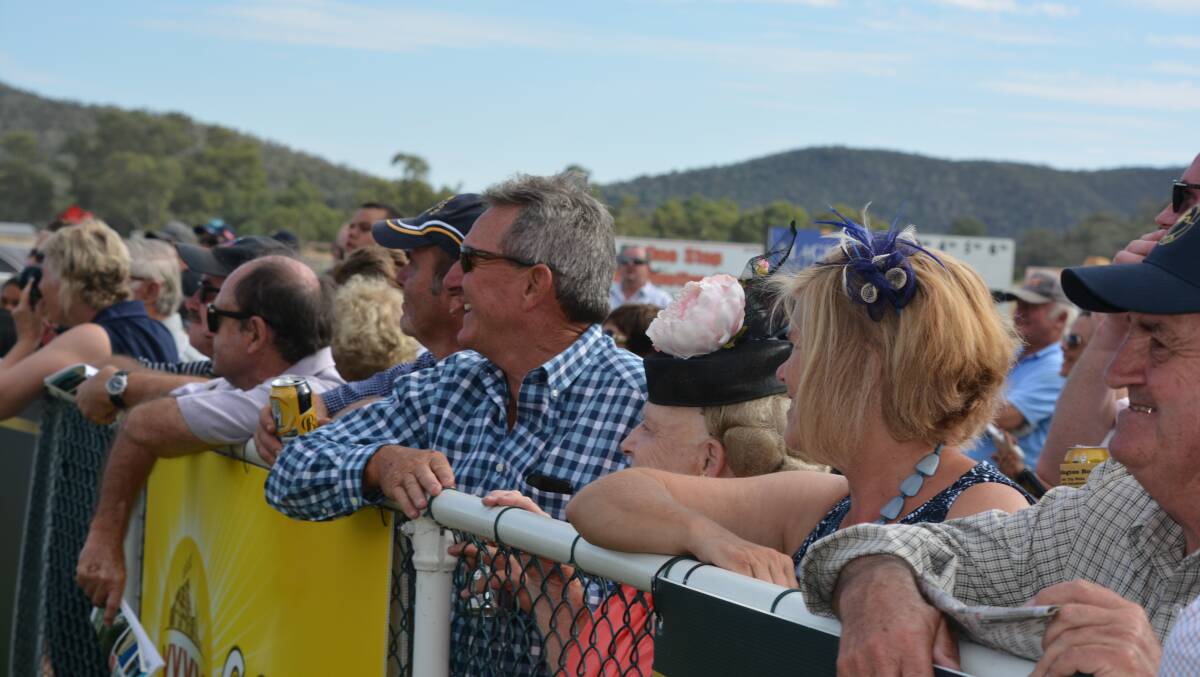 Thrilled punters cheer on Wellington Boot winner Lucy Rose. Photo: NICK GRIMM