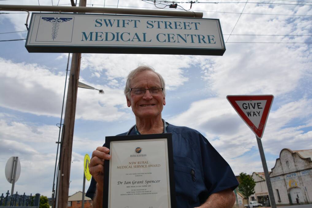 HONOURED: Dr Ian Spencer with his distinguished service award. Photo: NICK GRIMM.