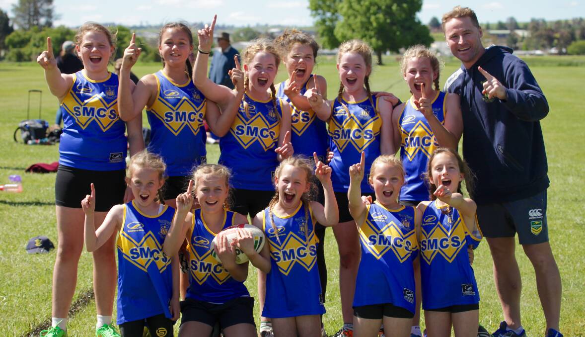 Winners are grinners: Bridgette Carney, Ella James, Claudia Whiteman, Millie Mills, Sophie Whiteman, Josie Clarke, Megan Connon, Bonnie Sheridan, Demi Owens, Lilly Clarke, Emily Smith and coach Alistaire Thompson after qualifying for the NSW Touch State Finals. Photo: Jo Ivey. 
