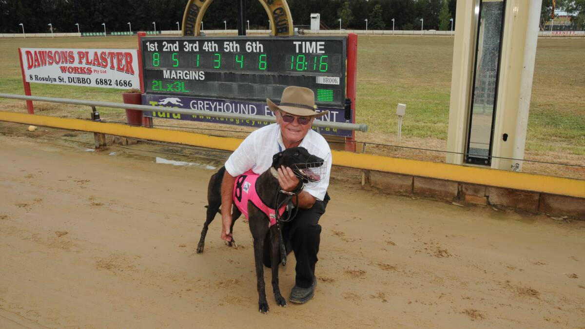 Relief: Wellington trainer Ron Steel, pictured with Susannah Cargo after one of his countless wins at Dubbo's Dawson Park, was pleased to hear the NSW government had moved to reverse its ban on greyhounds racing. File photo.