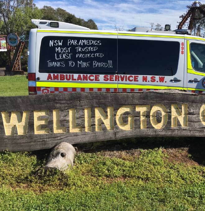 Campaign slogan: An ambulance at Wellington bears the signs of the campaign to reverse changes to death and disability coverage. Photo contributed. 