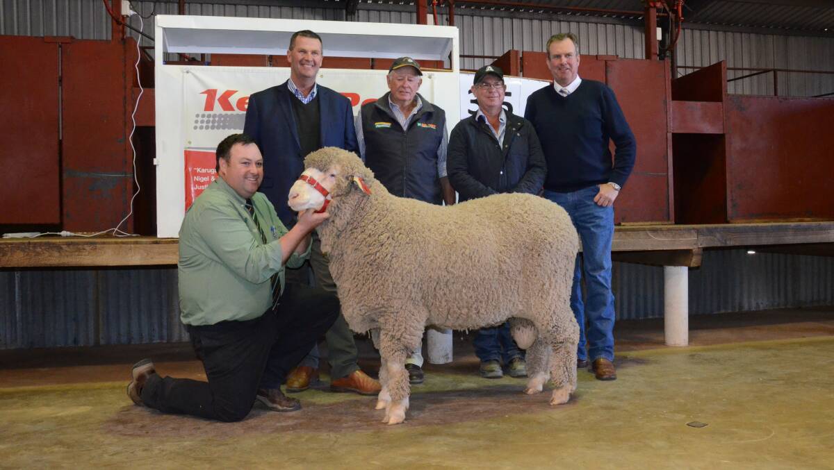 $26,000 SALE-TOPPER: Landmark's Dubbo Merino sheep specialist, Brad Wilson, Nigel Kerin, buyers, Adrian and Neil Newton, "Combadery", Walgett, and auctioneer, Paul Dooley, Tamworth.