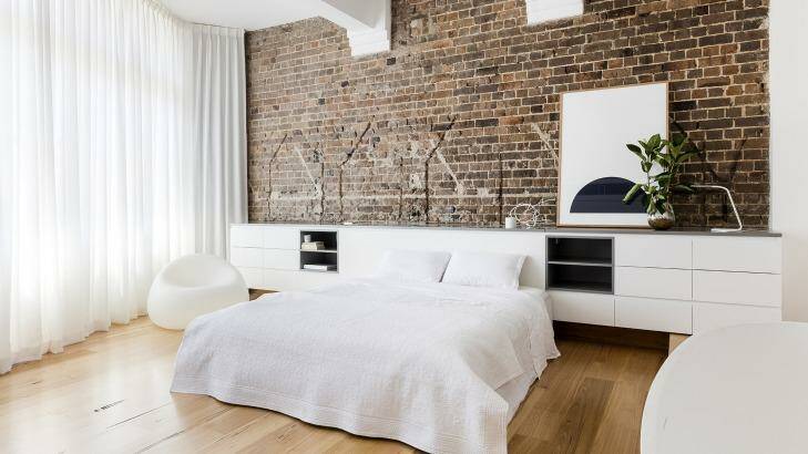 The exposed brickwork and wooden floors given an industrial, but homely, feel to the apartment. Photo: Supplied
