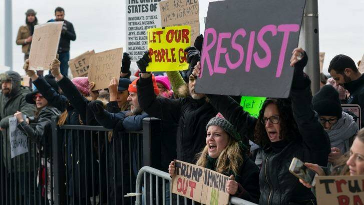 Protesters assemble at John F Kennedy International Airport in New York after two Iraqi refugees were detained while trying to enter the country. Photo: AP Photo/Craig Ruttle