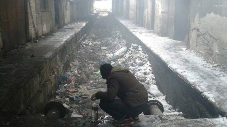 Refugees in the snowy cold warehouses in Serbia. Photo: CARE/NSHC/Markovic