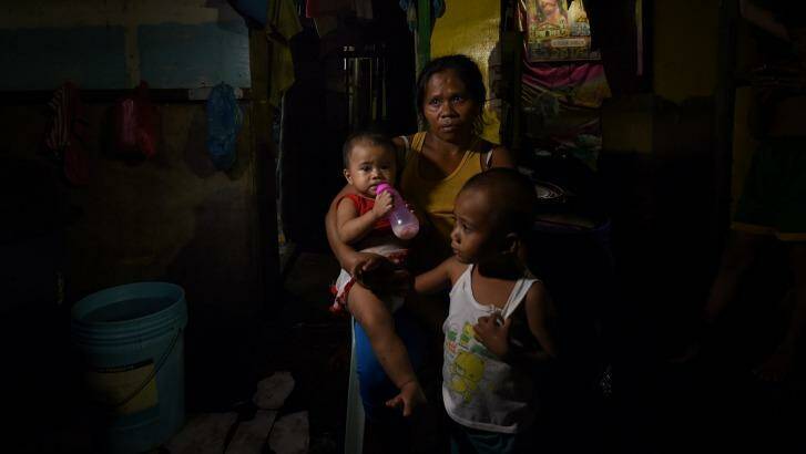 Ruth-Jane Sombrio whose husband was shot dead at home, with her daughter Rogielyn and son Rogie Sebastian. Photo: Kate Geraghty