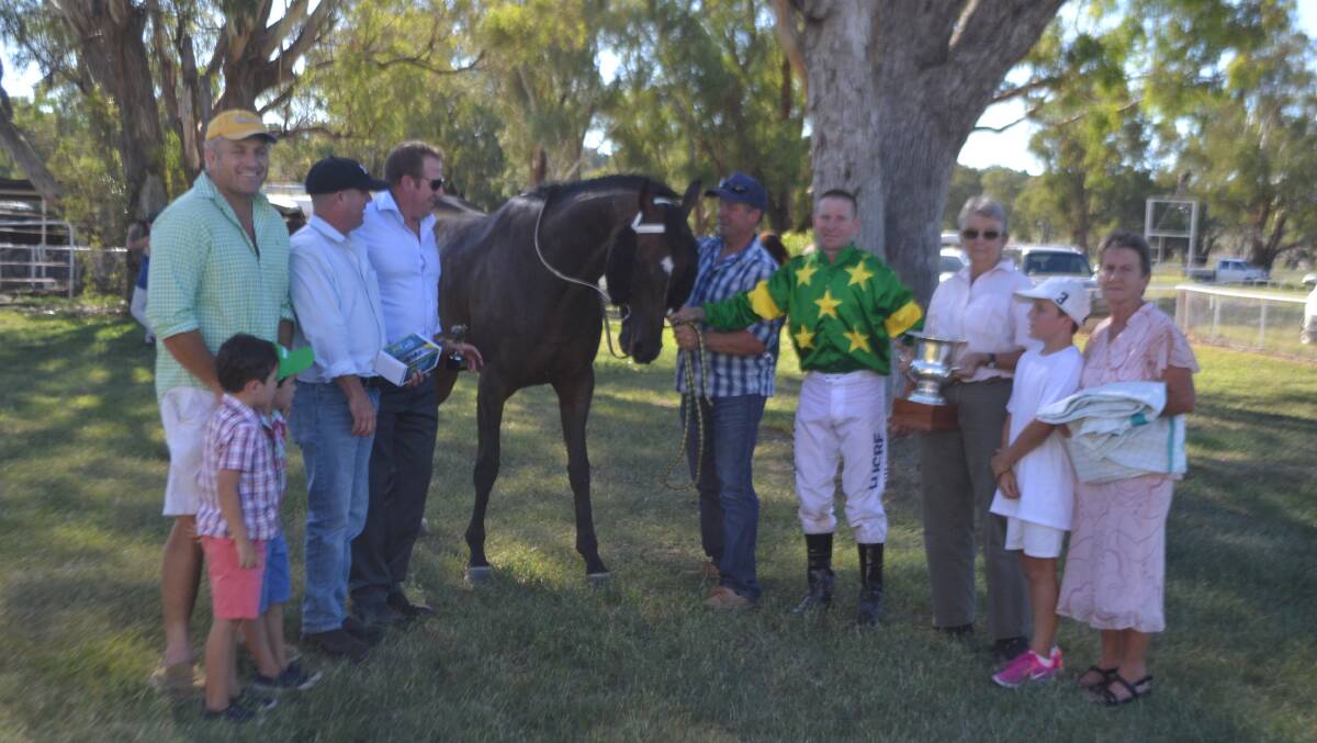 The Mason and Wilkin families together with jockey Tim Phillips and trainer Brett Thompson with the winning trophy.
