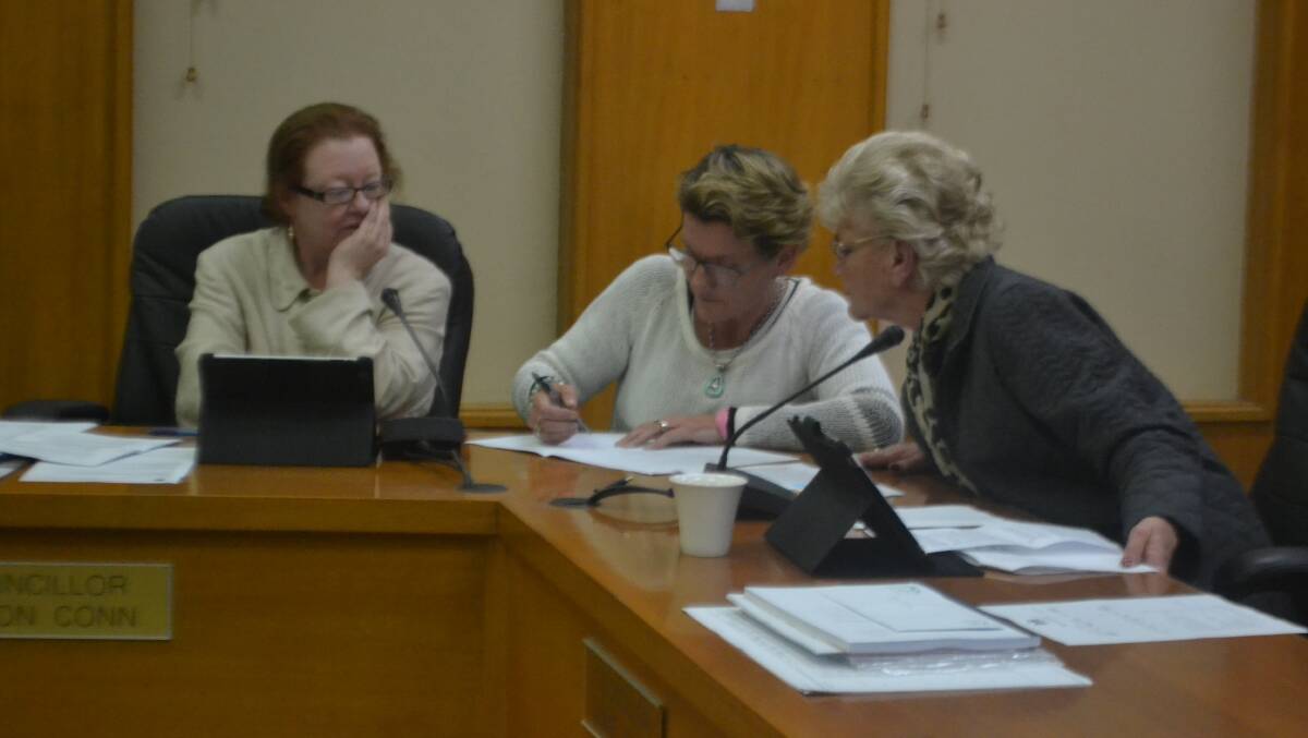 Cr's Conn, Smith and Jones look over CBD Beautification plans during Wednesday night's meeting.