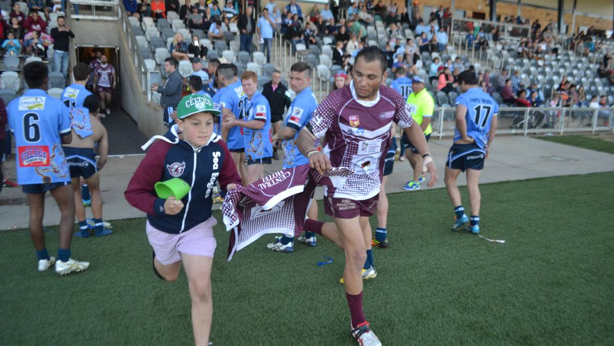 Nathan Thompson carries his brothers jersey onto the field, honoured to carry Chris's number onto the ground