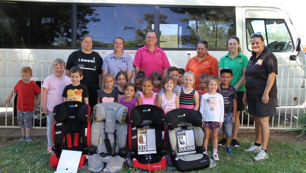 Children and community with child seat restraints at Nanima
