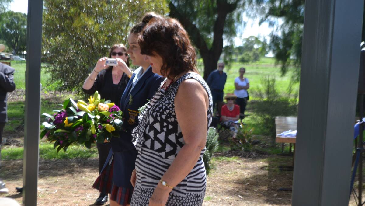 Georgina Parkes and Maureen Milgate take a wreath to lay at the service