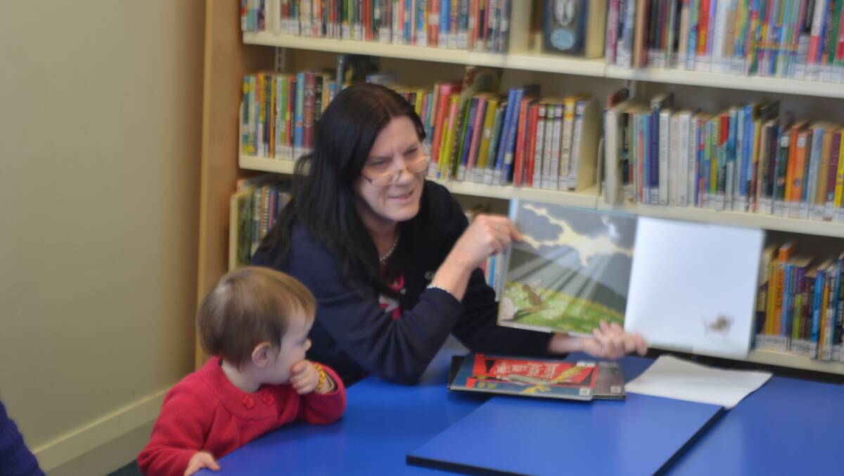 Librarian Anne Pope reads to children at Wellington Library.