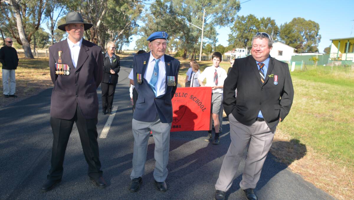 Craig Morris, Noel Burns and Jason Kirk prepare to walk for Anzac Day at Mumbil