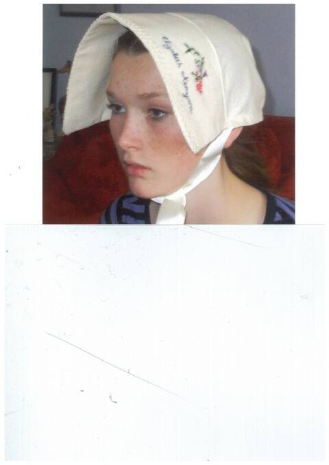 Paige Tolhurst wearing a bonnet made for her great, great, great grand mother