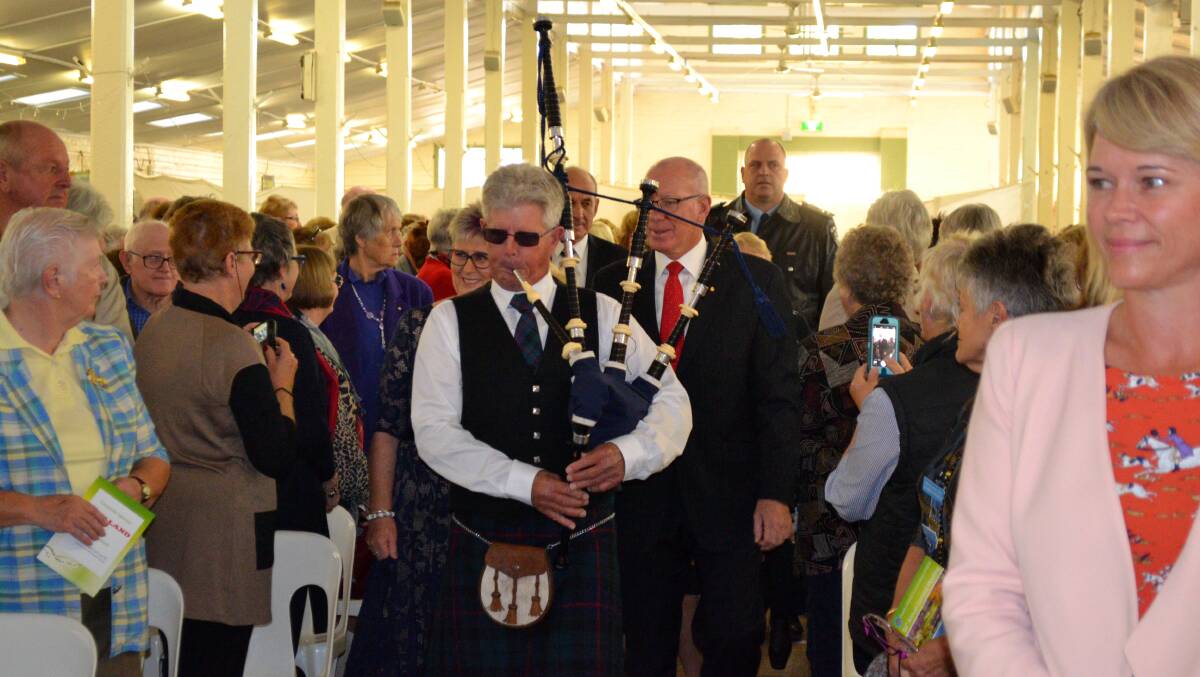 Bagpipes lead NSW Governor General David Hurley and CWA president Tanya Cameron into the hall at Cowra