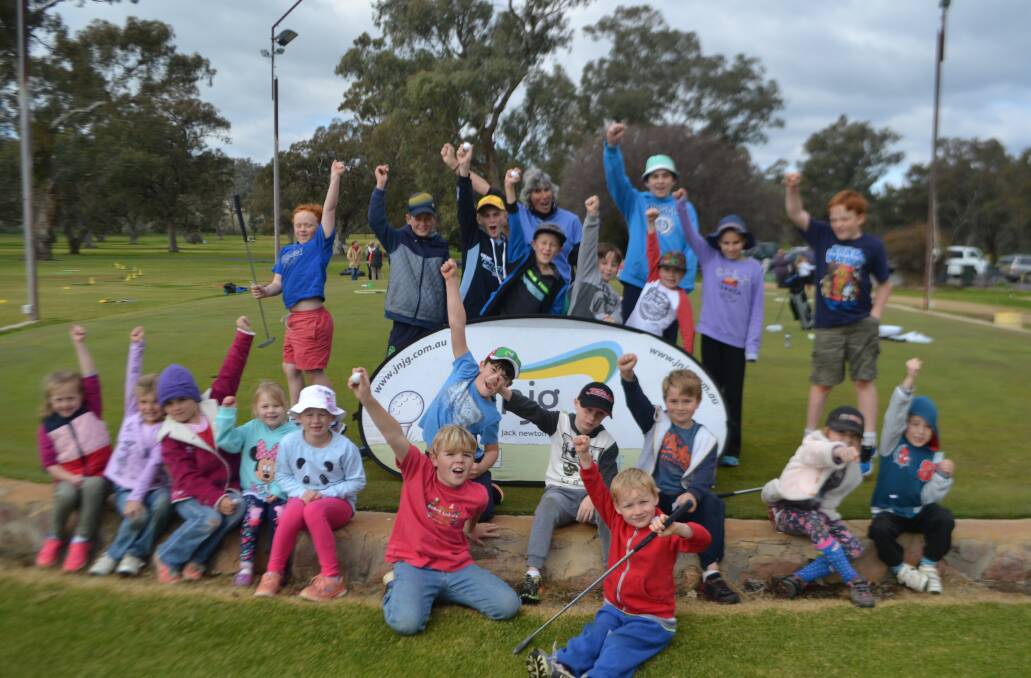Children salute the great game of golf on Thursday at a clinic