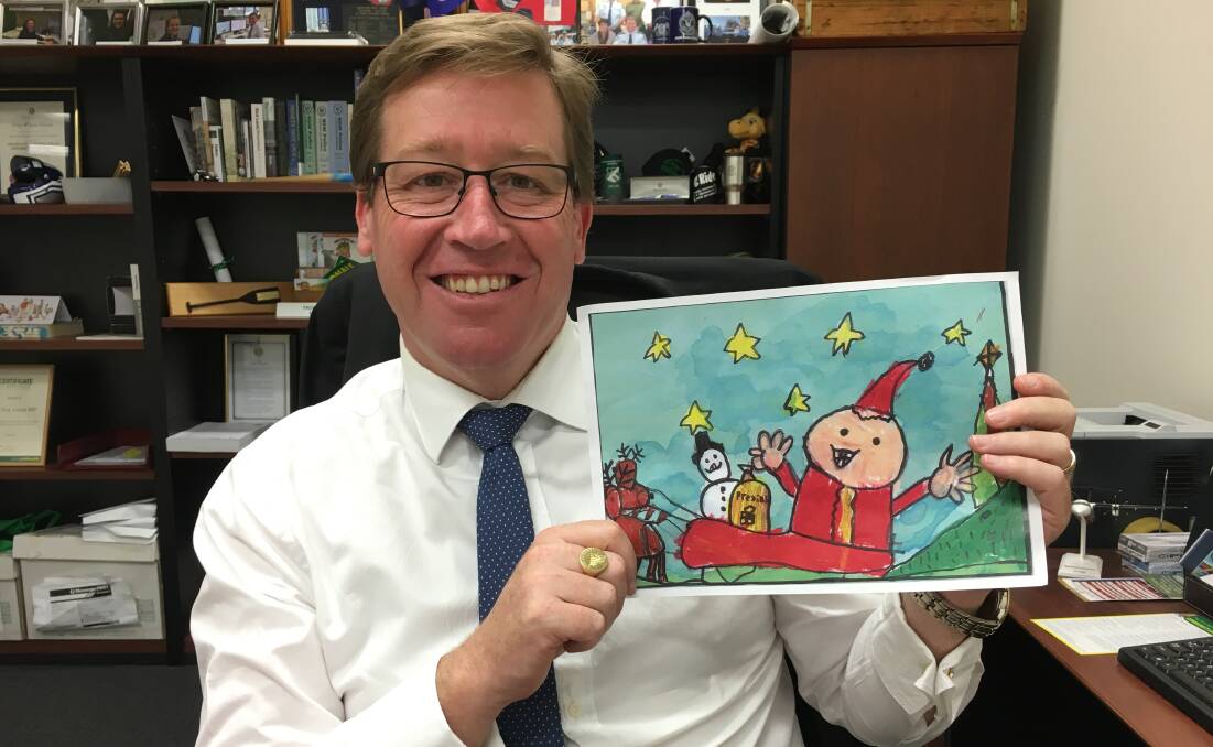 FESTIVE CHEER: Troy Grant shows the work of Maggie Blackman, of Mudgee Public School, who won the Christmas card competition.