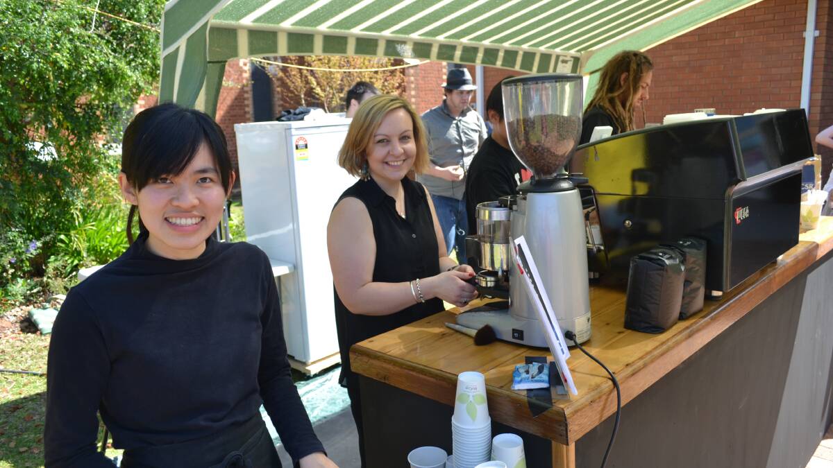 Melanie Tonniges and Vinn Wong serve coffee from the Midnite Cafe stand at the Uniting Church Hall in Dubbo. Funds raised by the sale of coffee will go to the Midnite Cafe, which uses the church hall.
