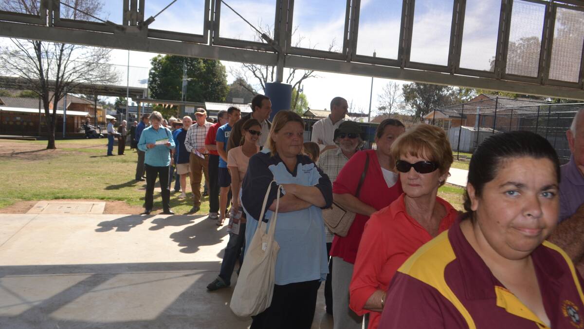 Long lines of people waited to vote at the Wellington Public school earlier today.