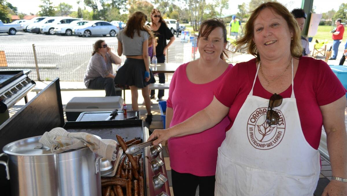 Tracey Anderson and Jenny Brayshaw operate the barbecue at Orana Heights Public School on election day. they, like the Delroy Campus use sausages from the Bourke St Butchery and swear by them. Parents and supporters of the school also baked cakes and slices which were all but sold out by 1pm.