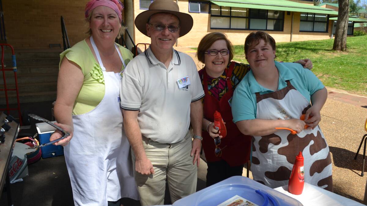 Delroy campus P&C members, Sally and Earle Shields with Susie Hines were running the barbecue at Delroy campus in Dubbo. With them was Leah Bayliss who  was creating balloon animals.