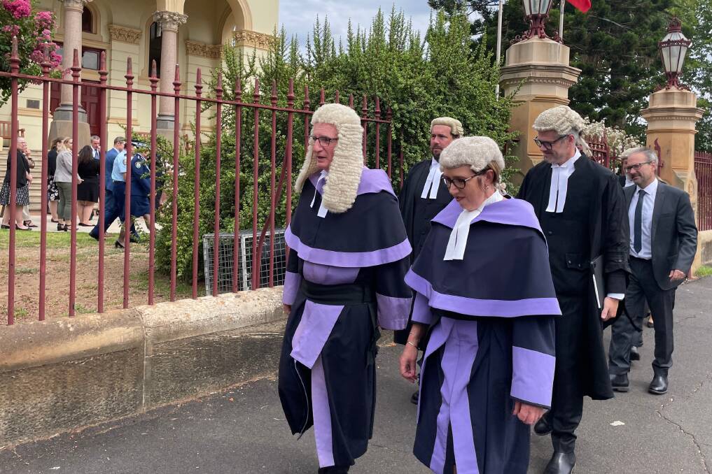 Justice Derek Price and District Court judge Karen Robinson lead the procession from Dubbo Courthouse to the Holy Trinity Anglican Church. Picture by Allison Hore