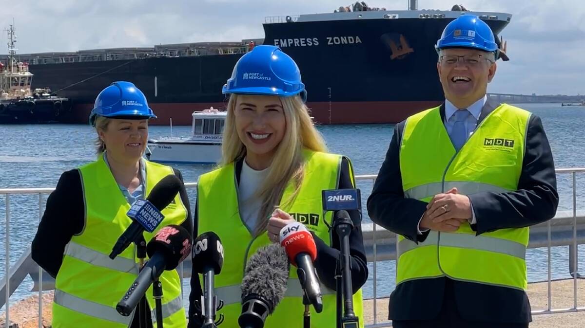 Liberal candidates Nell McGill and Brooke Vitnell and Prime Minister laughed when a foghorn interrupted their press conference in the Port of Newcastle on Monday. 
