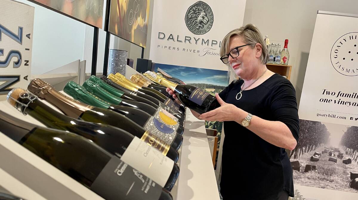 BUBBLY BOTTLENECK: Michele Round with her collection of Tasmanian sparkling wines at the Pinot Shop in Launceston. Picture: Joshua Peach 