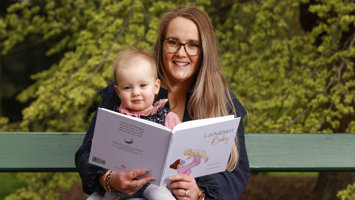 Laura Feldman reads her new book, Lockdown Baby, to daughter Winnie. Photo: Luke Hermer. 