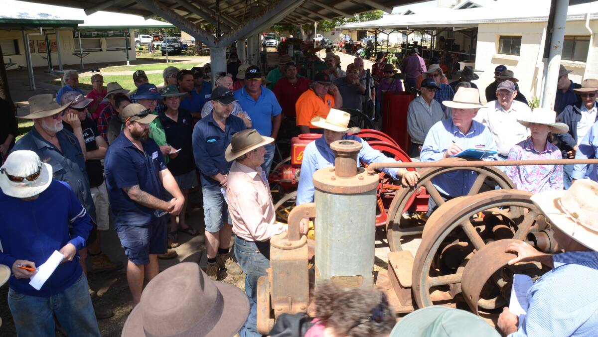 Kym Monkton at left keeps bidding to win this Ronaldson and Tippet oil engine from his $8000 bid.