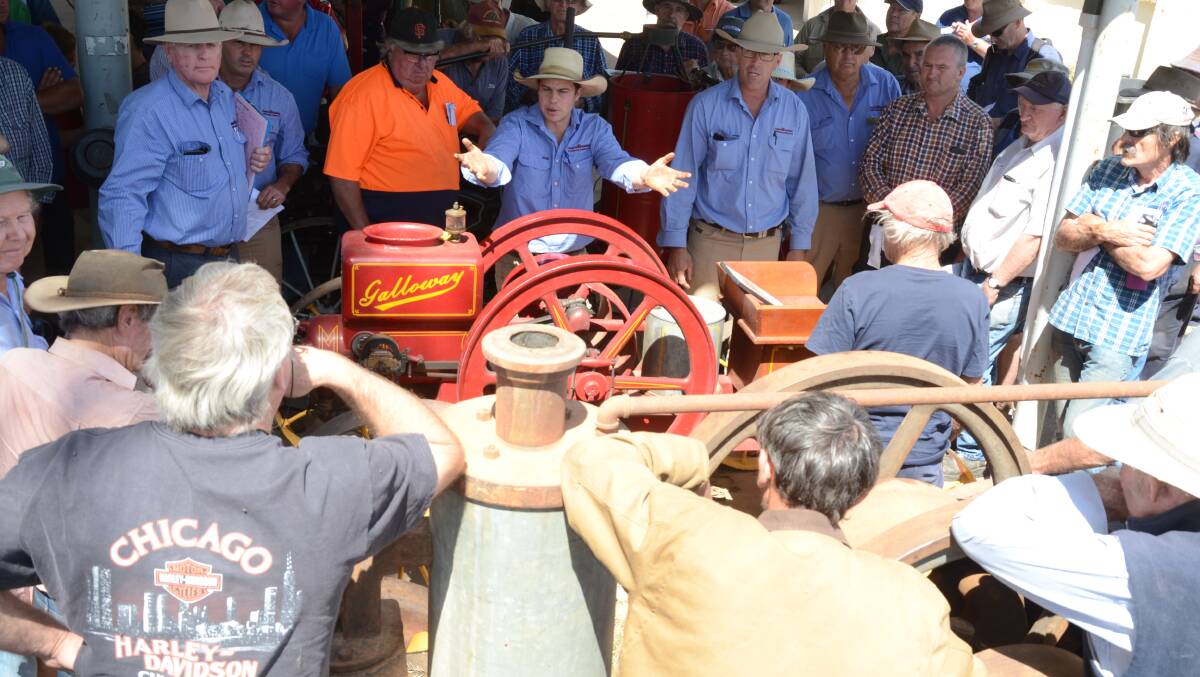 Peter Milling and Company auctioneers Tom Pollard and Danny Tink in action as they secure bids up to $8000 for this Galloway stationary engine.