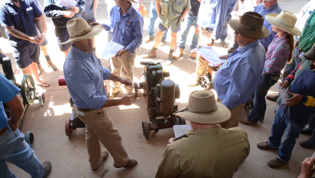 John Hyland in action as he knocks down a small stationary emngine during the auction.