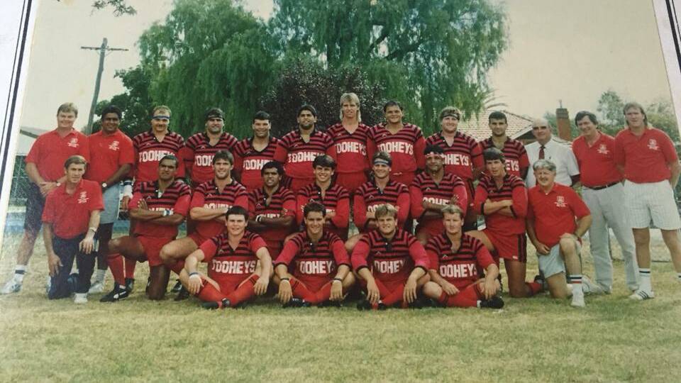 RED AND BLACK: Mick Peachey with the 1990 Group 11 representative side. 