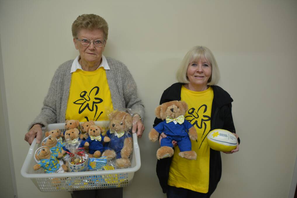 Sharing hope: Volunteers Rae Batho and Patty Neville with some of the Daffodil Day merchandise last year. 