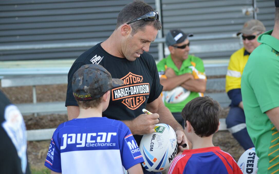 COMING BACK: Sydney Roosters legend Brad Fittler makes a couple of young fans' day Waratahs Sportsground last year, he's bringing the Hogs For Homeless Tour back to the colour city later this month. Photo: MATT FINDLAY