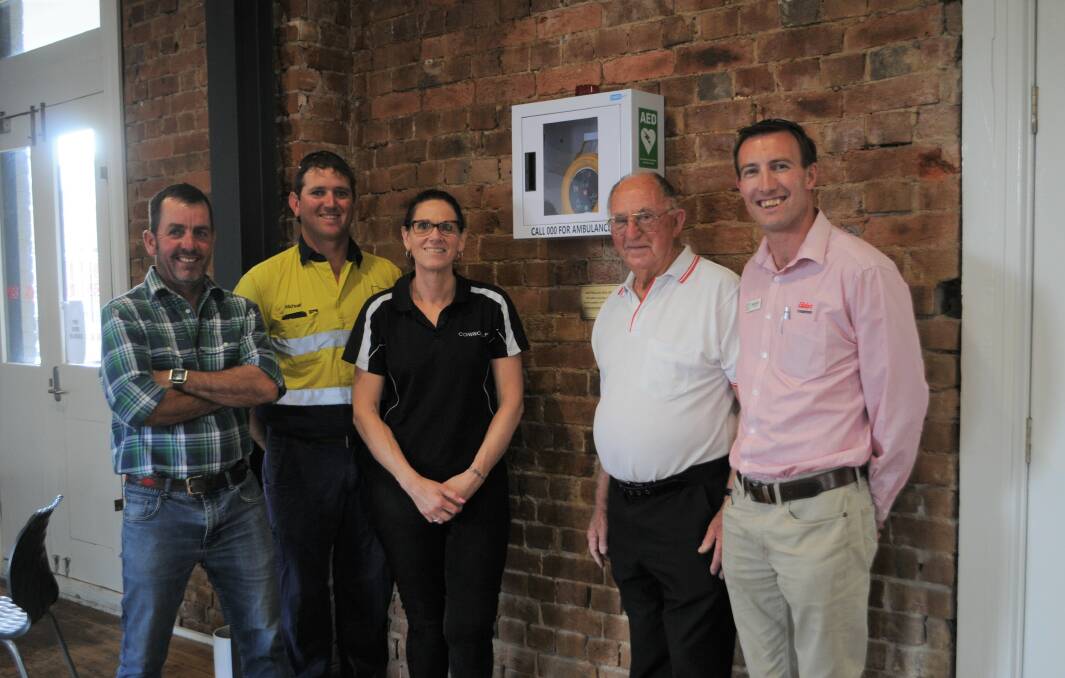 Campaign: Simon Barton, Michael Bullock, Cow and Calf owner Kellee Gersbach, first aid trainer George Chapman and David Grant at the installation of the automated external defibrillator. Photo: Taylor Jurd. 