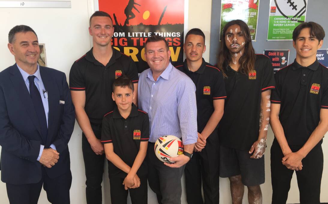 Kicking goals: Wellington High principal Rod Cosier, Clotarf operations manager Mason Williams and Dubbo MP Dugald Saunders with students from the Clontarf Academy.