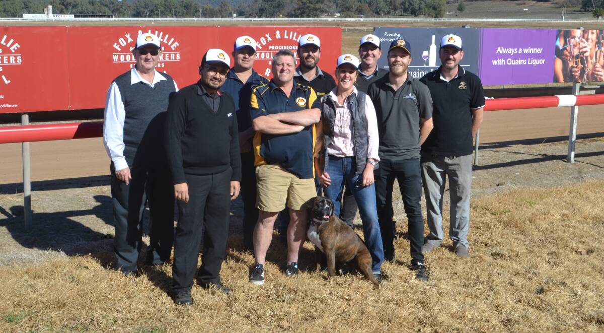Tickled Pink: Ian Darney with the club's sponsors from KFC, Kierle's Chemist, Hermitage Hill, Wellington Soldiers Club, One Stop Automotive Shop, Quain's Liquor and Fox and Lillie (missing) plus Fred the dog. Photo: Taylor Jurd. 