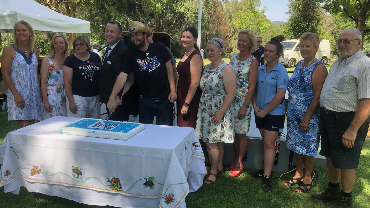The 2019 Australia Day award winners cut the celebratory cake alongside the Ambassador and mayor Ben Shields. Photo: File. 