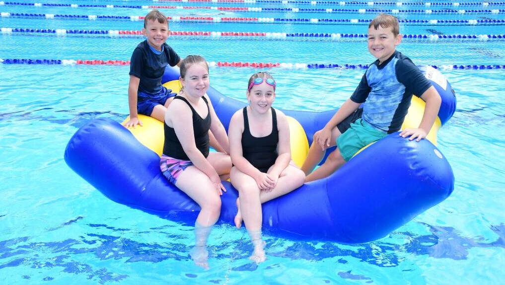 FUN IN THE SUN: Ayden Powyer, Briannah and Madalyn Hundy with Cameron McKenzie at the Dubbo pool earlier this year. Photo: AMY McINTYRE
