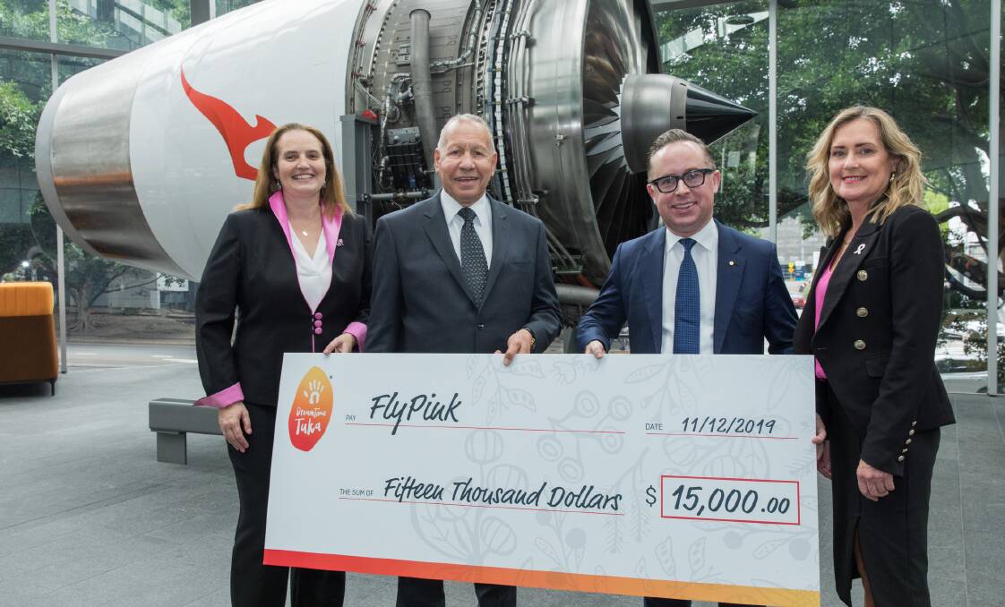 Raising funds: Dreamtime Tuka founder Herb Smith presenting the $15,000 donation to Qantas. Photo: Supplied. 
