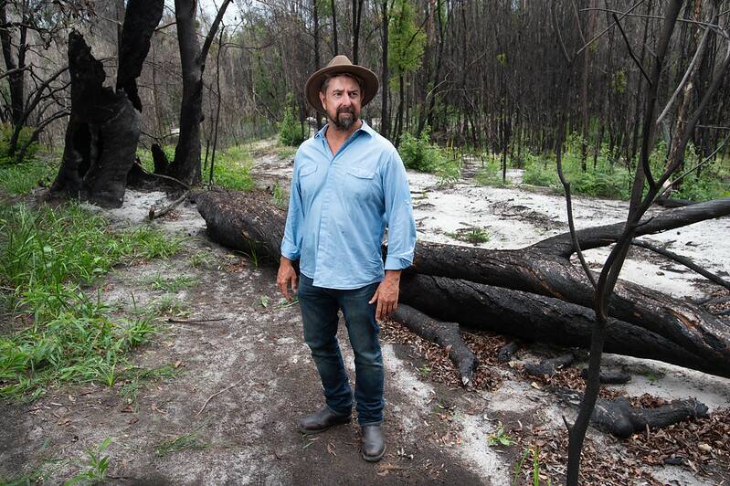 QUT ecologist Associate Professor Grant Hamilton pictured on a fireground near Noosa will use drone footage to determine koala populations after bushfires. Credit: QUT 