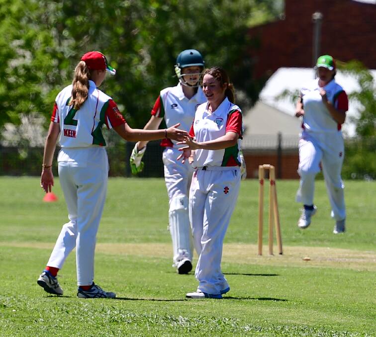 GOT IT: Amali McNeil (centre) celebrates the winning wicket for Western in Thursday's game against South Coast. Photo: ALEXANDER GRANT