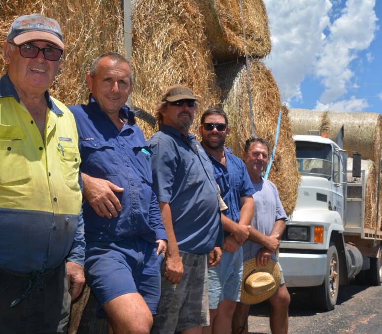 HELPING HANDS: Garry Todd, Tony Inder, John Turner, Tom Whiteley and Stuart Edwards with two of the trucks taking hay to burnt out properties. Photo: NICK GRIMM